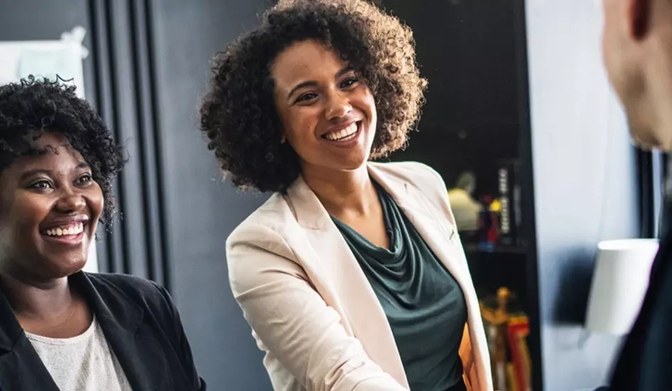 business woman shaking hands representing how to track affilliate sales